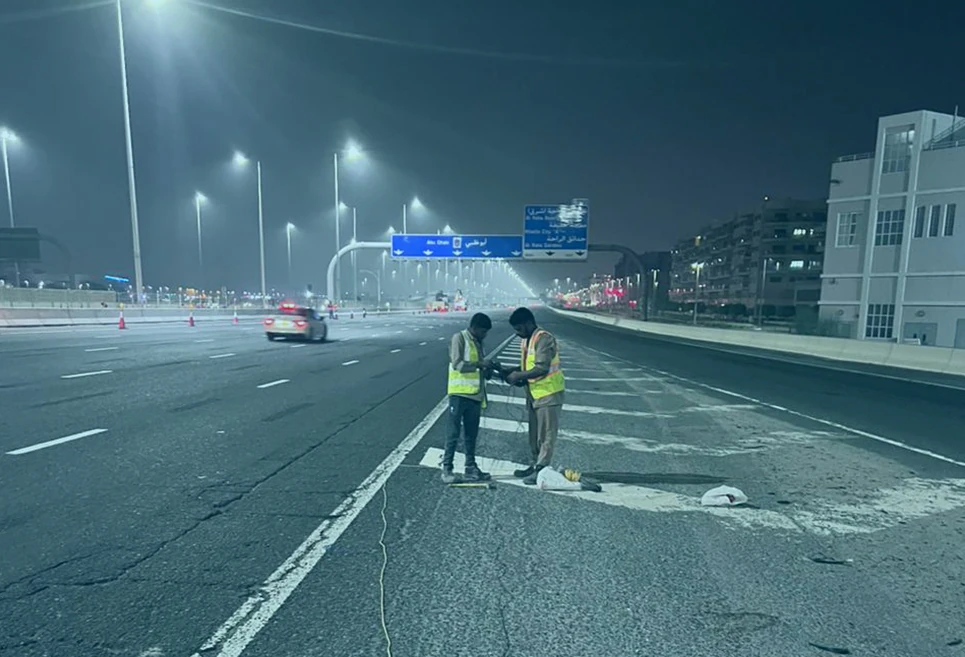 Inframax engineering crew executing nighttime guidance systems validation at highway shoulder checkpoint